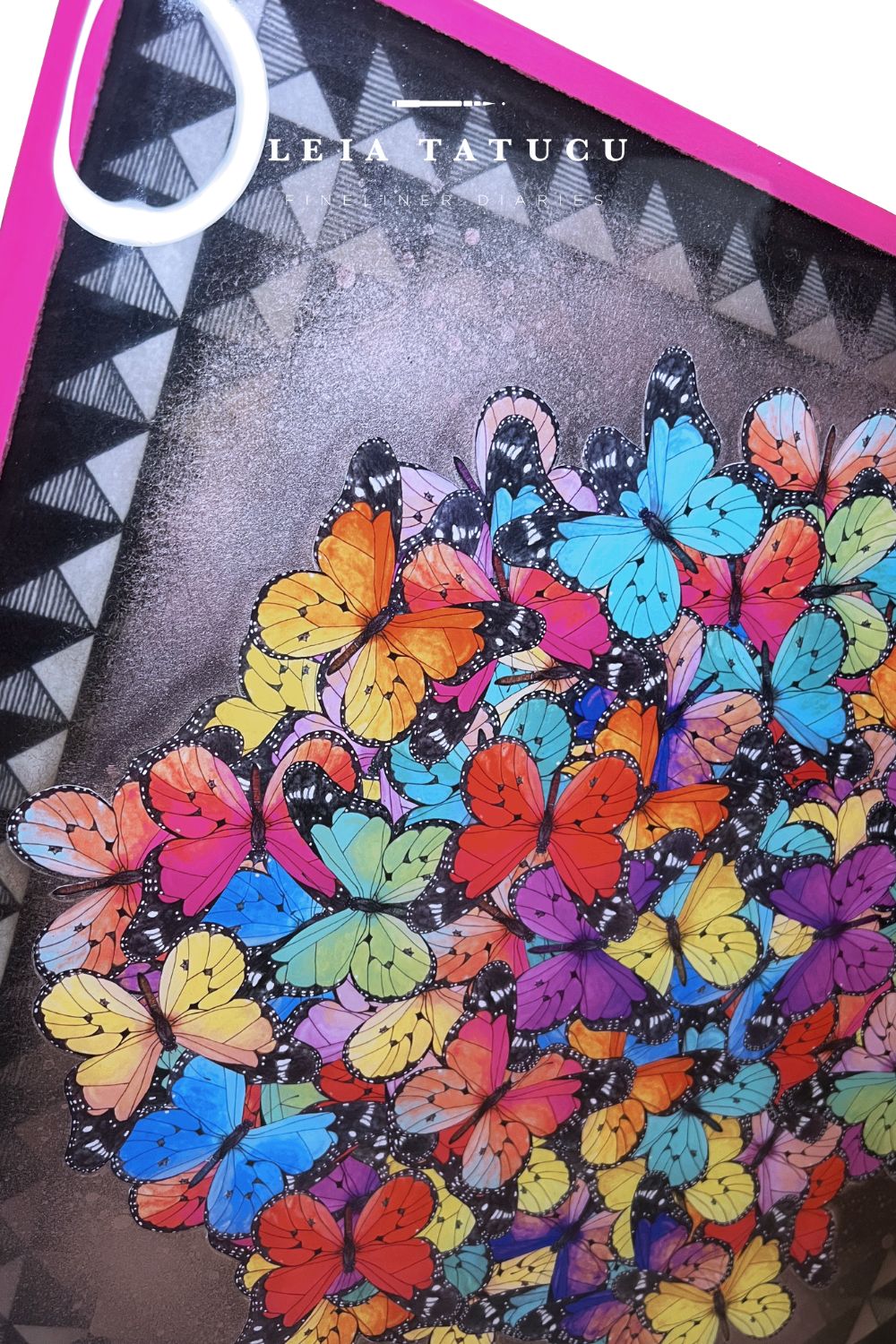 Colorful butterfly pattern against a black and white geometric background and with a glossy resin sealing.