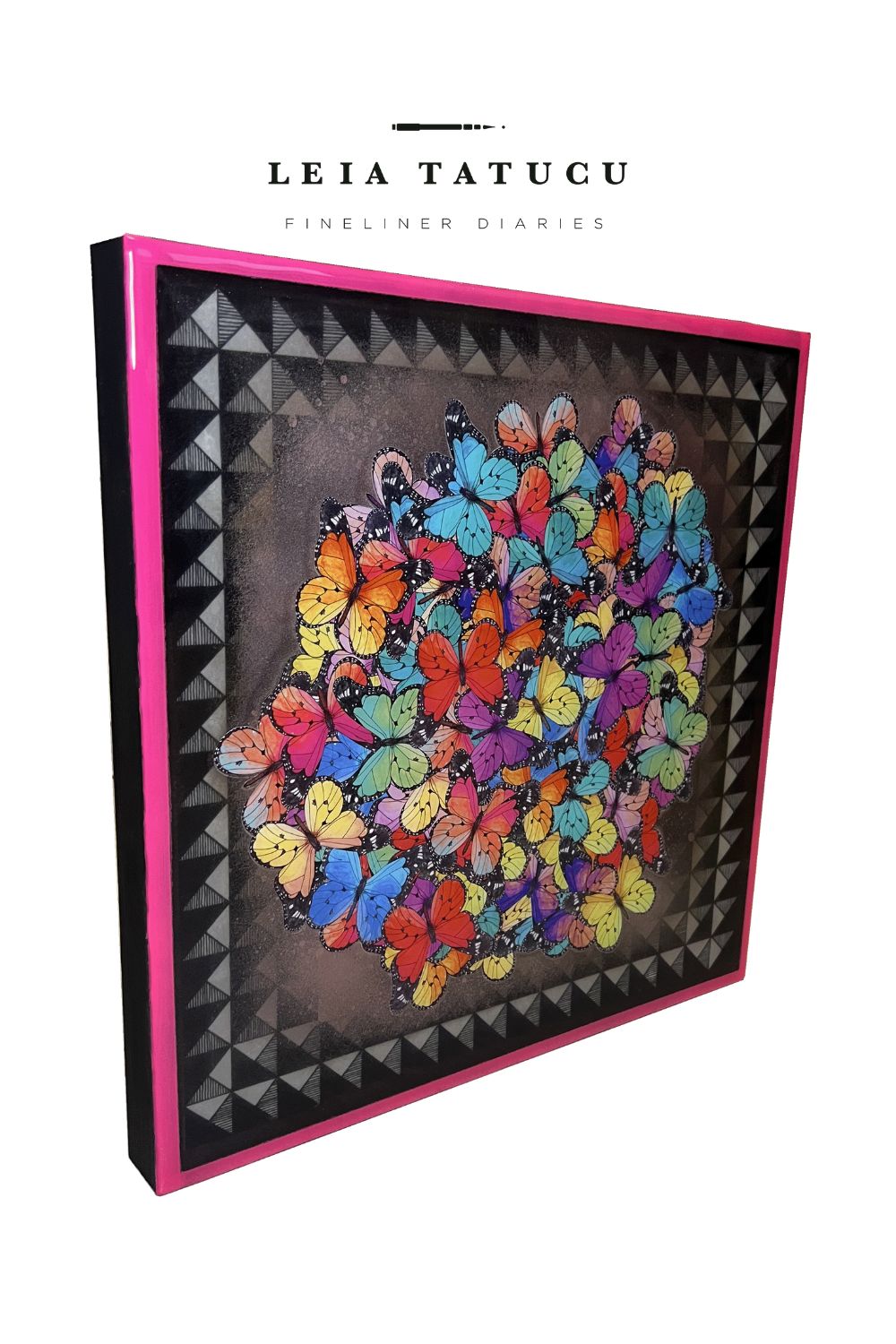 Colorful butterfly abstract artwork with a hot pink painted margin, seen from the side.